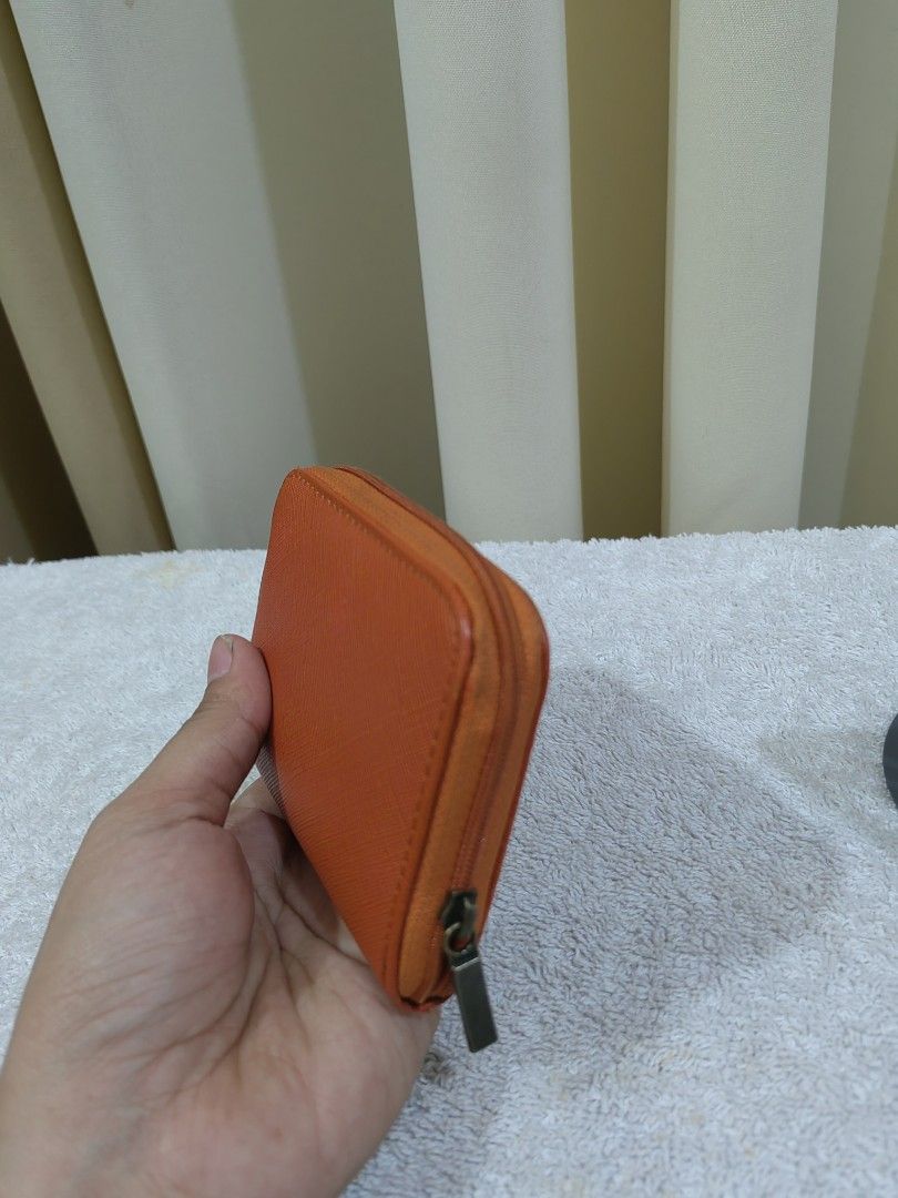 Orange Coin Pouch/ card with Cat Charm (Category: Purses & Pouches) located in Makati City. Submitted by prelovedtreatedwithlove (Listing ID 1463739462, Image 3). Description: - Cute orange coin pouch - Zipper closure for security - Multiple compartments inside for coins and cards - Adorable small metal cat charm on the front - Ideal for keeping your small essentials neatly organized -sign of use only .