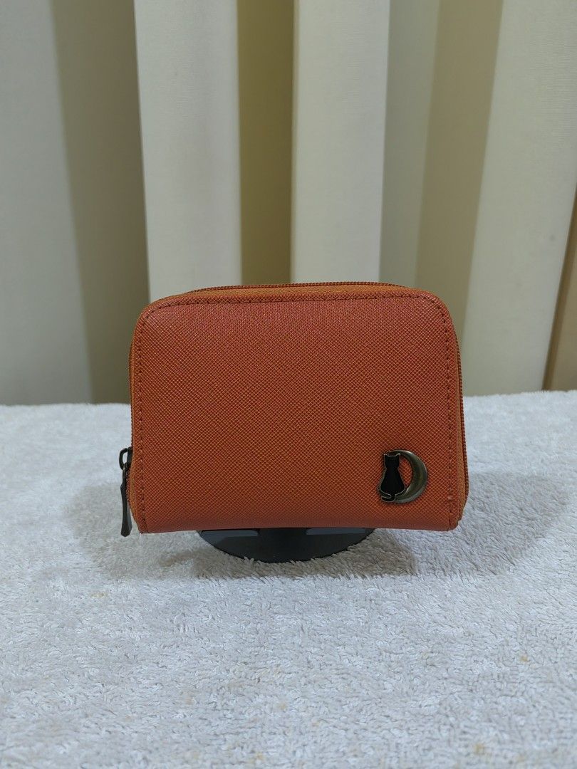 Orange Coin Pouch/ card with Cat Charm (Category: Purses & Pouches) located in Makati City. Submitted by prelovedtreatedwithlove (Listing ID 1463739462, Image 1). Description: - Cute orange coin pouch - Zipper closure for security - Multiple compartments inside for coins and cards - Adorable small metal cat charm on the front - Ideal for keeping your small essentials neatly organized -sign of use only .