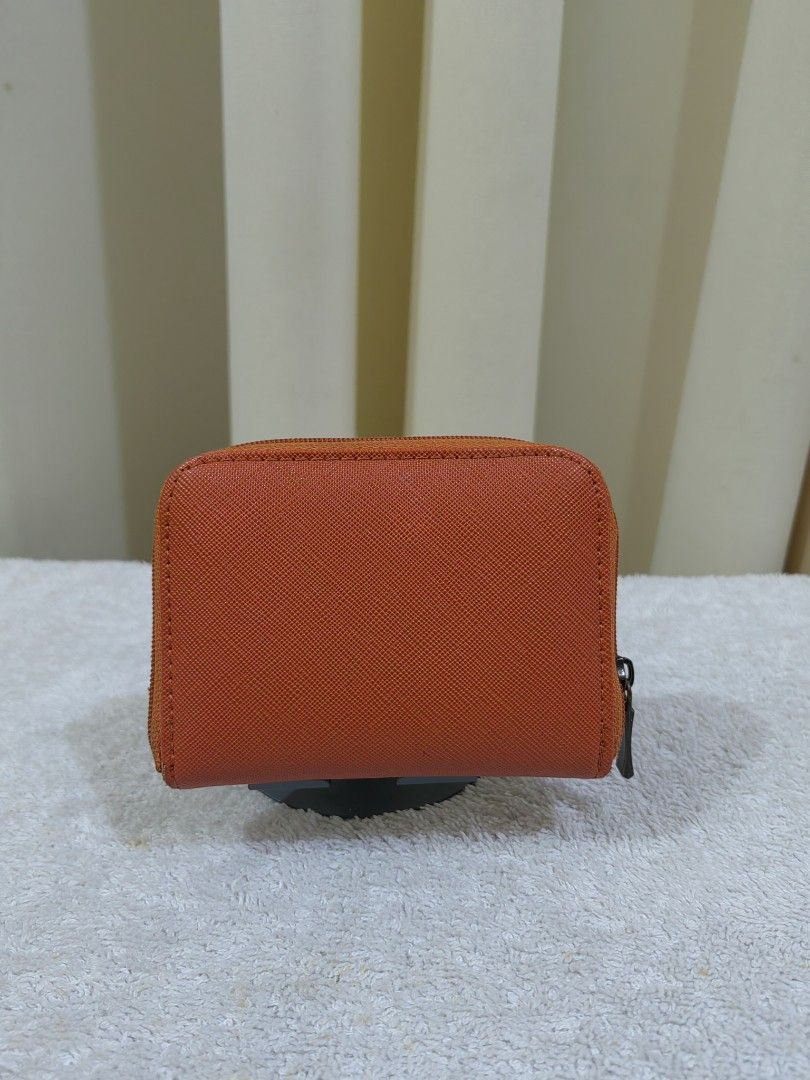 Orange Coin Pouch/ card with Cat Charm (Category: Purses & Pouches) located in Makati City. Submitted by prelovedtreatedwithlove (Listing ID 1463739462, Image 2). Description: - Cute orange coin pouch - Zipper closure for security - Multiple compartments inside for coins and cards - Adorable small metal cat charm on the front - Ideal for keeping your small essentials neatly organized -sign of use only .