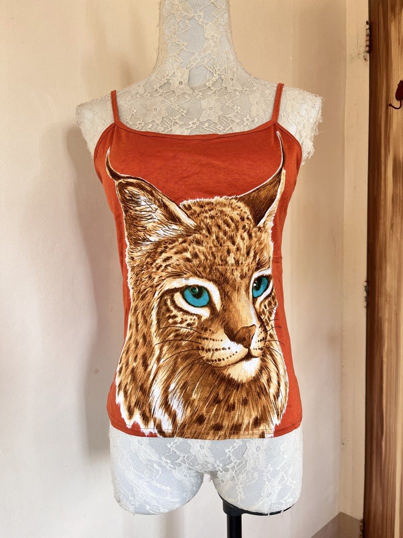 Orange Graphic Camisole top (Category: Sleeveless) located in San Jose. Submitted by thymies (Listing ID 1463646378, Image 2). Description: Key features:Style: Cami / Spaghetti Strap Tank Top Neckline: Straight / Scooped Color: Bright Orange Graphic: Graphic wildlife art (Lynx / Wildcat.