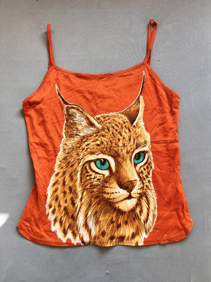 Orange Graphic Camisole top (Category: Sleeveless) located in San Jose. Submitted by thymies (Listing ID 1463646378, Image 1). Description: Key features:Style: Cami / Spaghetti Strap Tank Top Neckline: Straight / Scooped Color: Bright Orange Graphic: Graphic wildlife art (Lynx / Wildcat.