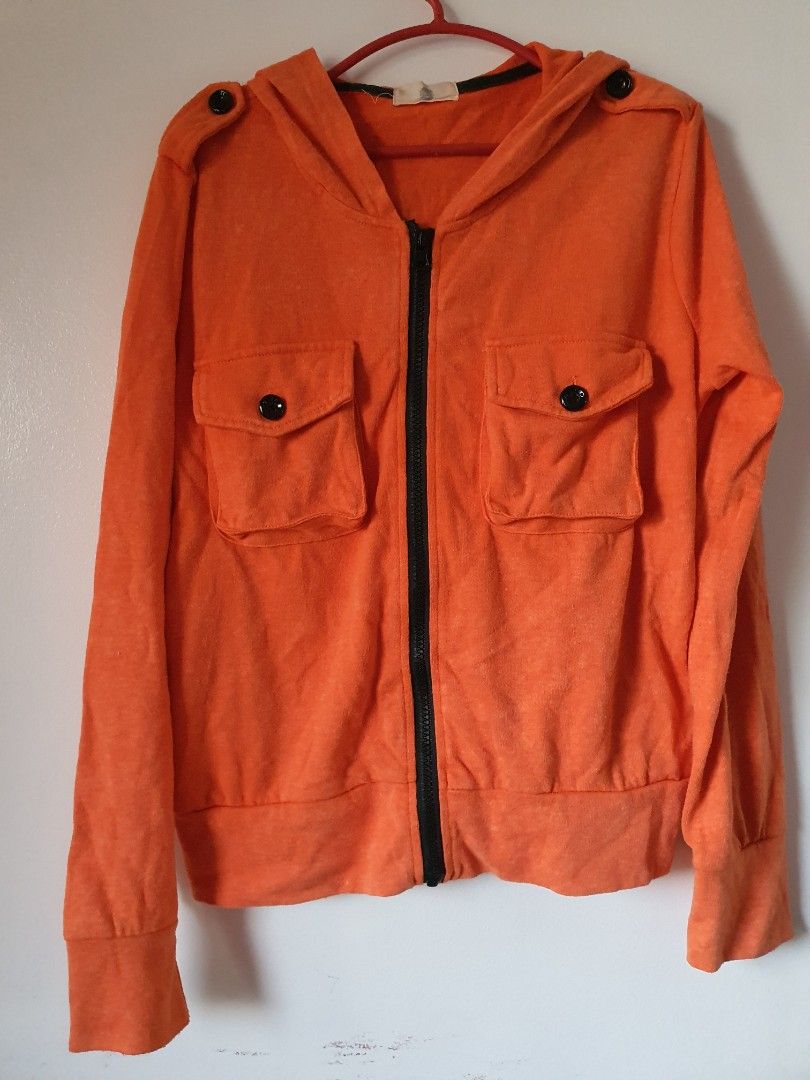 Orange Mickey Mouse Hoodie Jacket (Category: Coats, Jackets and Outerwear) located in Meycauayan. Submitted by shoptoown (Listing ID 1463569204, Image 1). Description: - Orange zip-up hoodie jacket - Features a cool Mickey Mouse graphic on the back - Two chest pockets with secure button closure - Long sleeves with comfortable ribbed cuffs - Made from soft fabric, ideal for everyday casual wear - Approximate measurement: 20 inches from pit to pit.