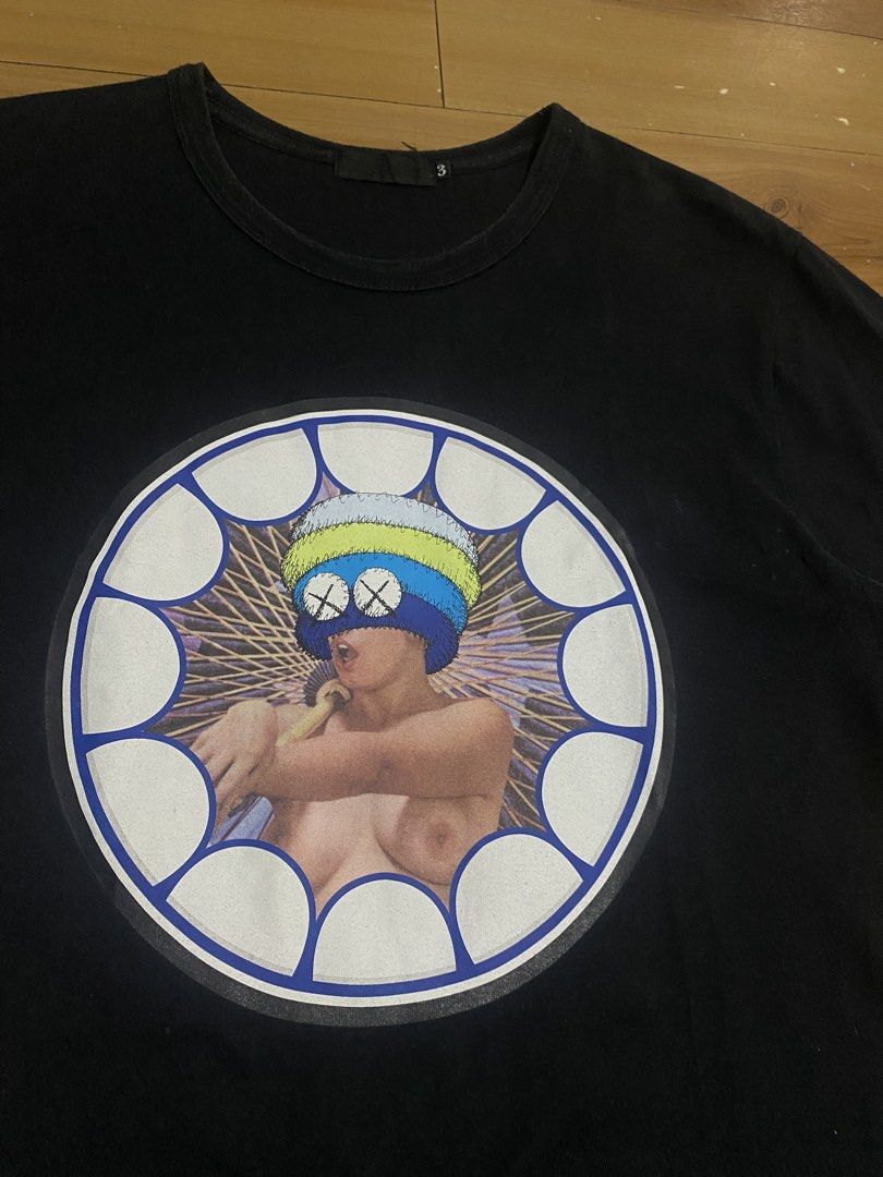 OriginalFake KAWS Graphic Tee Size 3 (Category: Tshirts & Polo Shirts ) located in Caloocan City. Submitted by NotYetDressed (Listing ID 1463716897, Image 2). Description: - Black OriginalFake T-shirt - Size 3 - 100% Cotton - Features a circular graphic print with a stylized figure on the front - Ideal for collectors.
