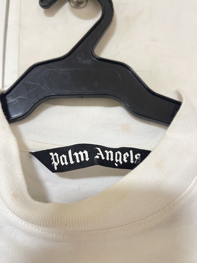 Palm Angels White T-Shirt - Dancing Bears (Category: Tshirts & Polo Shirts ) located in Paranaque City. Submitted by clubclassicz (Listing ID 1463692158, Image 2). Description: - Brand: Palm Angels - Size: Medium (M) - Material: 100% Cotton - Design: Features a fun Hawaiian-themed graphic of two bears - Logo: Palm Angels logo printed below the graphic - Chest: 23” - Length: 26” - Sleeves: 8 1/2” - Shoulders: 23”.