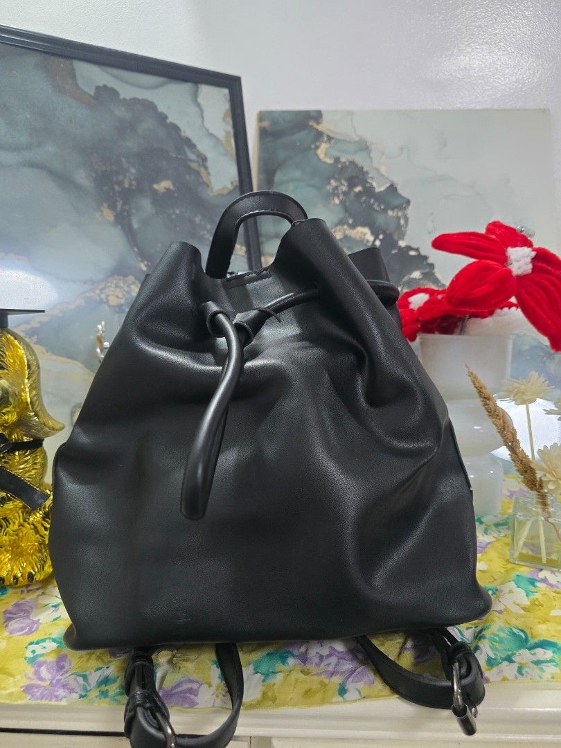 PARISIAN Black Faux Leather Drawstring Backpack (Category: Backpacks) located in Binan City. Submitted by geraldinef58404 (Listing ID 1463652743, Image 2). Description: - Brand: PARISIAN - Color: Black - Material: Faux Leather - Style: Drawstring Backpack - Features: Top handle, adjustable shoulder straps, magnetic snap closure - Interior: Spacious, ideal for essentials - Usage: Great for everyday wear.