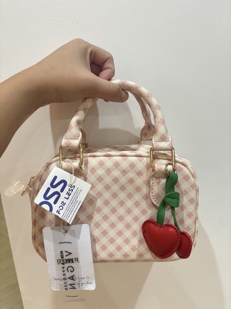Pink Gingham Mini Handbag with Cherry Charm (Category: Sling Bags) located in Bulacan. Submitted by ricammendz (Listing ID 1463665001, Image 1). Description: - Adorable pink gingham mini handbag - Features a fun cherry charm - Secure zipper closure - Ideal size for carrying essentials - Adds a vibrant pop of color to any outfit - Brand new with tags still attached.