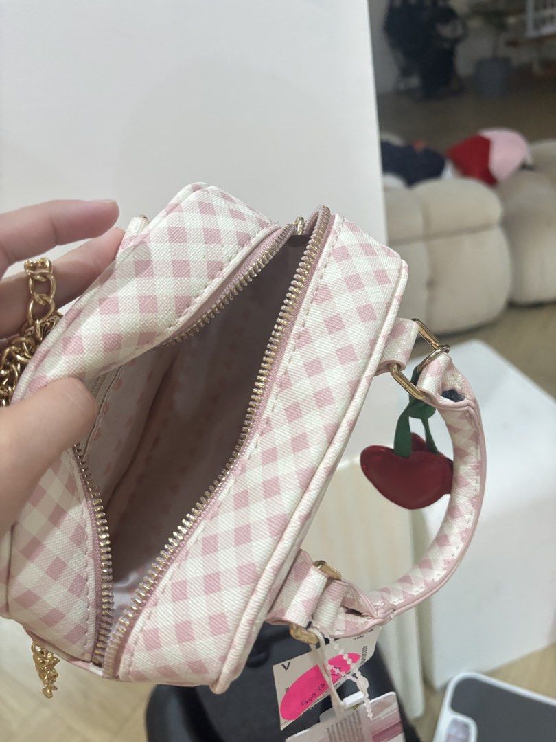 Pink Gingham Mini Handbag with Cherry Charm (Category: Sling Bags) located in Bulacan. Submitted by ricammendz (Listing ID 1463665001, Image 2). Description: - Adorable pink gingham mini handbag - Features a fun cherry charm - Secure zipper closure - Ideal size for carrying essentials - Adds a vibrant pop of color to any outfit - Brand new with tags still attached.