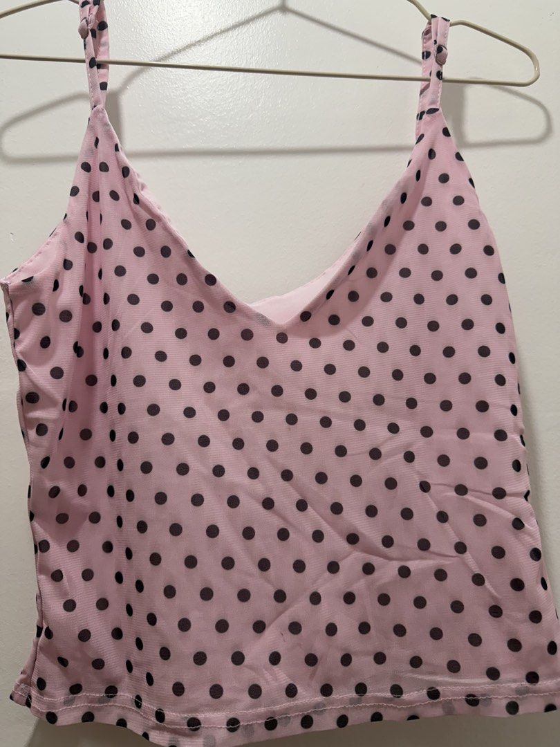 Pink Polka Dot Cami Tank Top (Category: Sleeveless) located in Rizal. Submitted by renee.ann (Listing ID 1463660254, Image 2). Description: - bought it for ₱350 - Cute pink cami tank top - Features black polka dots - Adjustable straps for a perfect fit - Lightweight and comfortable material - Versatile for layering or wearing on its own - Pairs well with jeans or shorts.