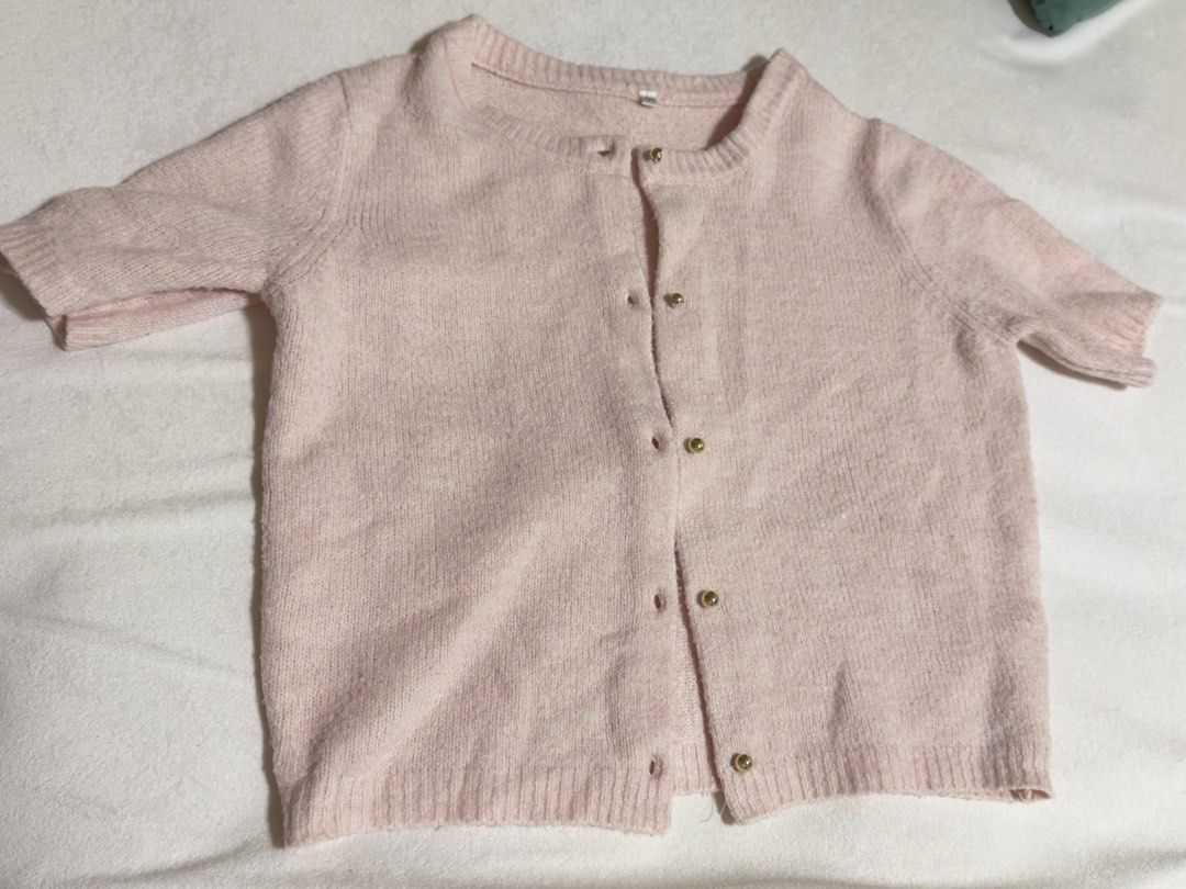Pink Short Sleeve Button Up Cardigan (Category: Blouses) located in Cebu City. Submitted by eynjlin (Listing ID 1463695547, Image 1). Description: - Light pink short sleeve cardigan - Features elegant gold buttons down the front - Made from a soft and slightly fuzzy material - Estimated size L - Ideal for layering over tops or dresses - Versatile for casual or slightly dressed-up occasions.