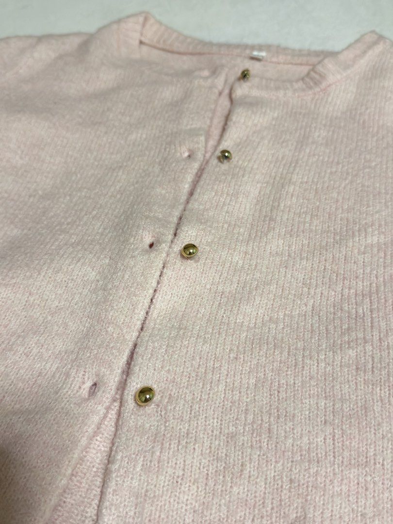Pink Short Sleeve Button Up Cardigan (Category: Blouses) located in Cebu City. Submitted by eynjlin (Listing ID 1463695547, Image 3). Description: - Light pink short sleeve cardigan - Features elegant gold buttons down the front - Made from a soft and slightly fuzzy material - Estimated size L - Ideal for layering over tops or dresses - Versatile for casual or slightly dressed-up occasions.