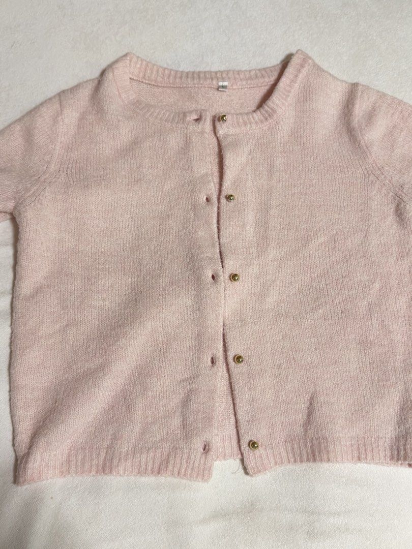 Pink Short Sleeve Button Up Cardigan (Category: Blouses) located in Cebu City. Submitted by eynjlin (Listing ID 1463695547, Image 2). Description: - Light pink short sleeve cardigan - Features elegant gold buttons down the front - Made from a soft and slightly fuzzy material - Estimated size L - Ideal for layering over tops or dresses - Versatile for casual or slightly dressed-up occasions.