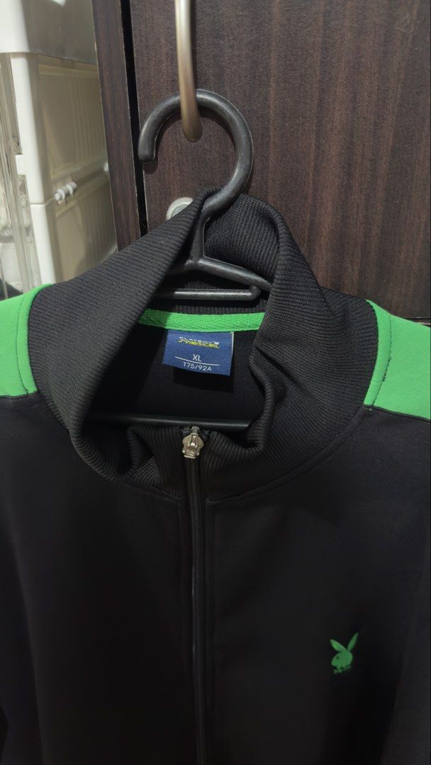 Playboy Black & Green Track Jacket XL (Category: Coats, Jackets and Outerwear) located in Bulacan. Submitted by jenelynichole (Listing ID 1463674017, Image 1). Description: - Playboy black track jacket - Size XL - Features green accents on shoulders and sleeves - Iconic Playboy bunny logo on chest - Full zip closure - Ribbed collar, cuffs, and hem for a comfortable fit.