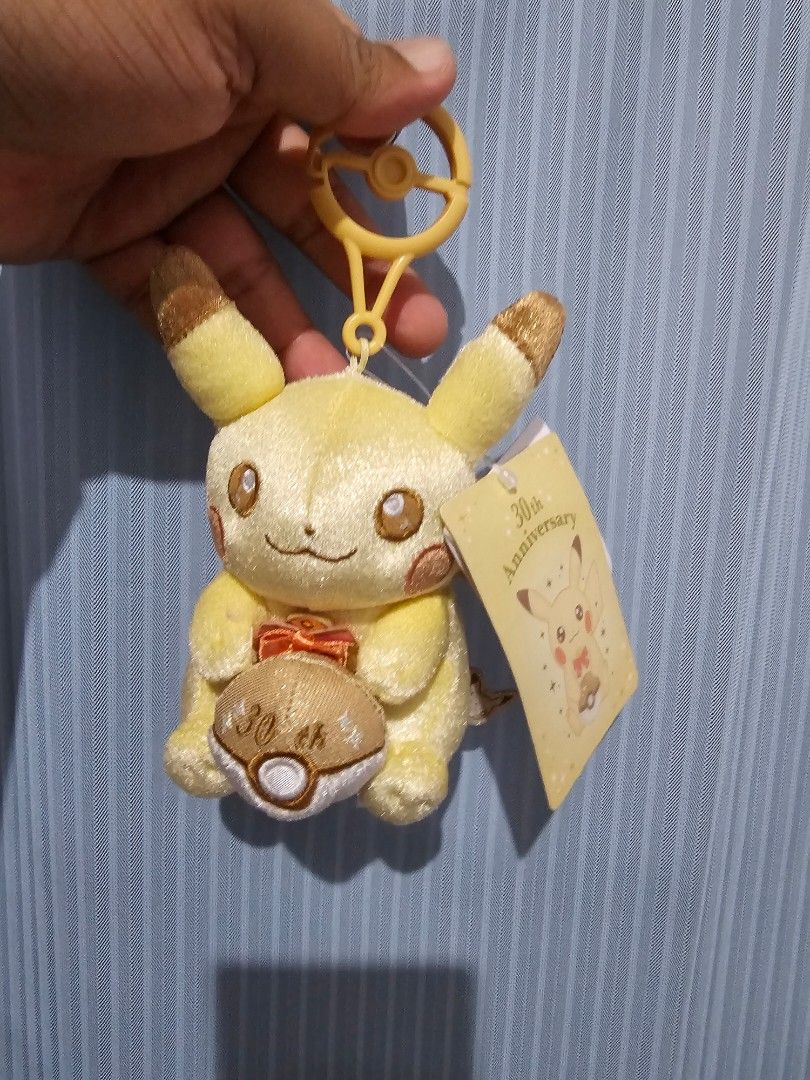 Pokemon Pikachu 30th Anniversary Plush Keychain (Category: Character Goods) located in General Santos City (Dadiangas). Submitted by pactoderetro (Listing ID 1463557894, Image 1). Description: - Super cute Pikachu plush keychain - 30th anniversary edition - Features a small orange ribbon - Includes a clip for easy attachment to bags or keys - Brand new with tag still attached - Ideal gift for any Pokemon fan.