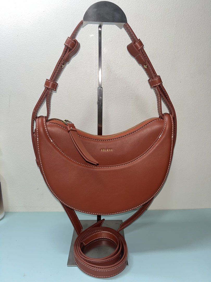 Polène Brea Bag in Brown (Category: Luxury Bags & Wallets) located in Liloan. Submitted by sakurumifinds2809 (Listing ID 1463721185, Image 1). Description: -from my personal collection. used only once complete with care card and dust bag - Genuine brown leather handbag - Elegant white stitching detail - Curved shape with secure zip closure - Adjustable shoulder strap for comfort - Stylish gold-tone hardware - Simple and chic design, ideal for dai