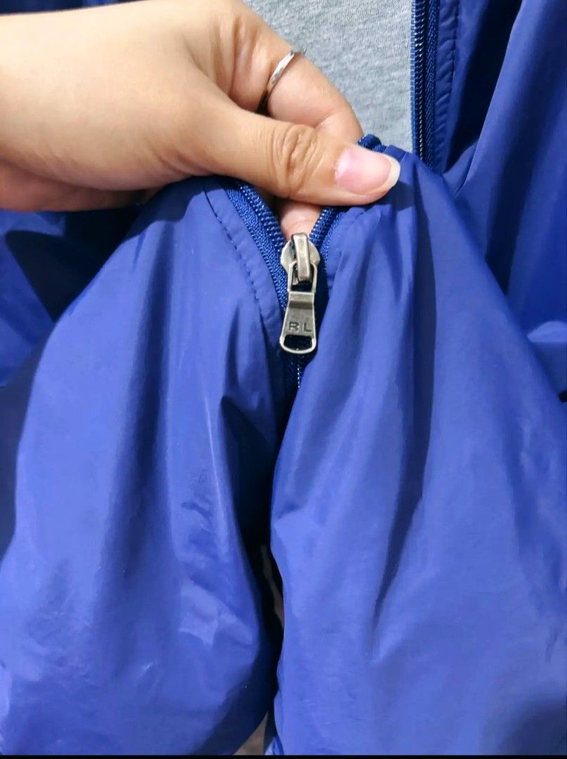 Polo Ralph Lauren Blue Hooded Jacket (Category: Coats, Jackets and Outerwear) located in Manila. Submitted by louiefinds26 (Listing ID 1463662981, Image 3). Description: - Blue hooded jacket from Polo Ralph Lauren - Iconic red pony logo on chest - Zipper closure with RL branded pull - Lightweight material, ideal for layering - Size medium - Great for casual wear or outdoor activities.