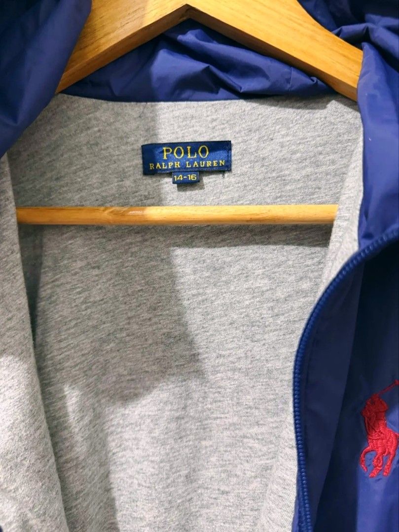 Polo Ralph Lauren Blue Hooded Jacket (Category: Coats, Jackets and Outerwear) located in Manila. Submitted by louiefinds26 (Listing ID 1463662981, Image 2). Description: - Blue hooded jacket from Polo Ralph Lauren - Iconic red pony logo on chest - Zipper closure with RL branded pull - Lightweight material, ideal for layering - Size medium - Great for casual wear or outdoor activities.