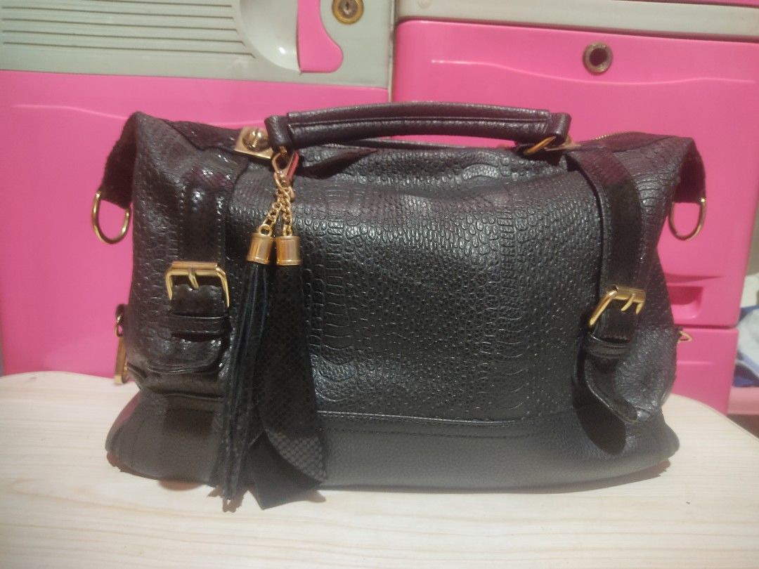 Polo Rose Black Textured Handbag (Category: Luxury Bags & Wallets) located in Manila. Submitted by xiaochao.16 (Listing ID 1463738524, Image 2). Description: - Brand: Polo Rose - Color: Black - Material: Textured - Closure: Main zip compartment - Interior: Internal pockets - Hardware: Gold details - Accent: Detachable tassel charm - Carrying Options: Top handles or shoulder strap.