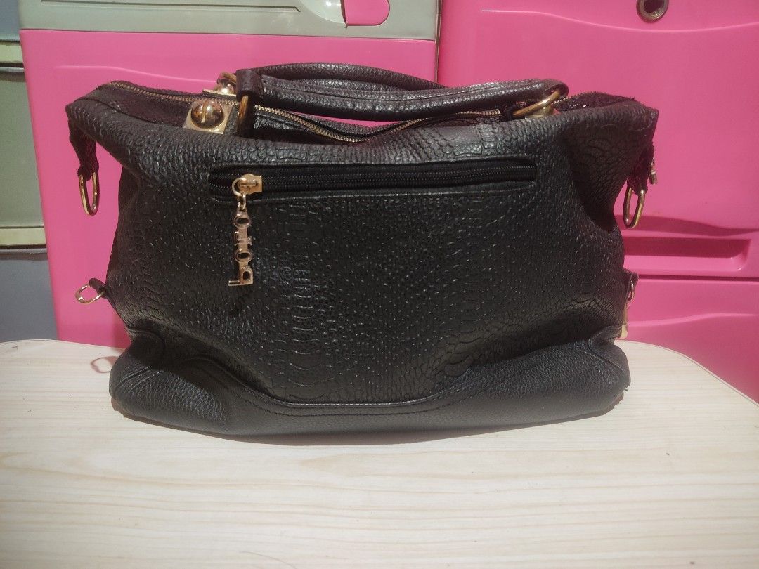 Polo Rose Black Textured Handbag (Category: Luxury Bags & Wallets) located in Manila. Submitted by xiaochao.16 (Listing ID 1463738524, Image 3). Description: - Brand: Polo Rose - Color: Black - Material: Textured - Closure: Main zip compartment - Interior: Internal pockets - Hardware: Gold details - Accent: Detachable tassel charm - Carrying Options: Top handles or shoulder strap.