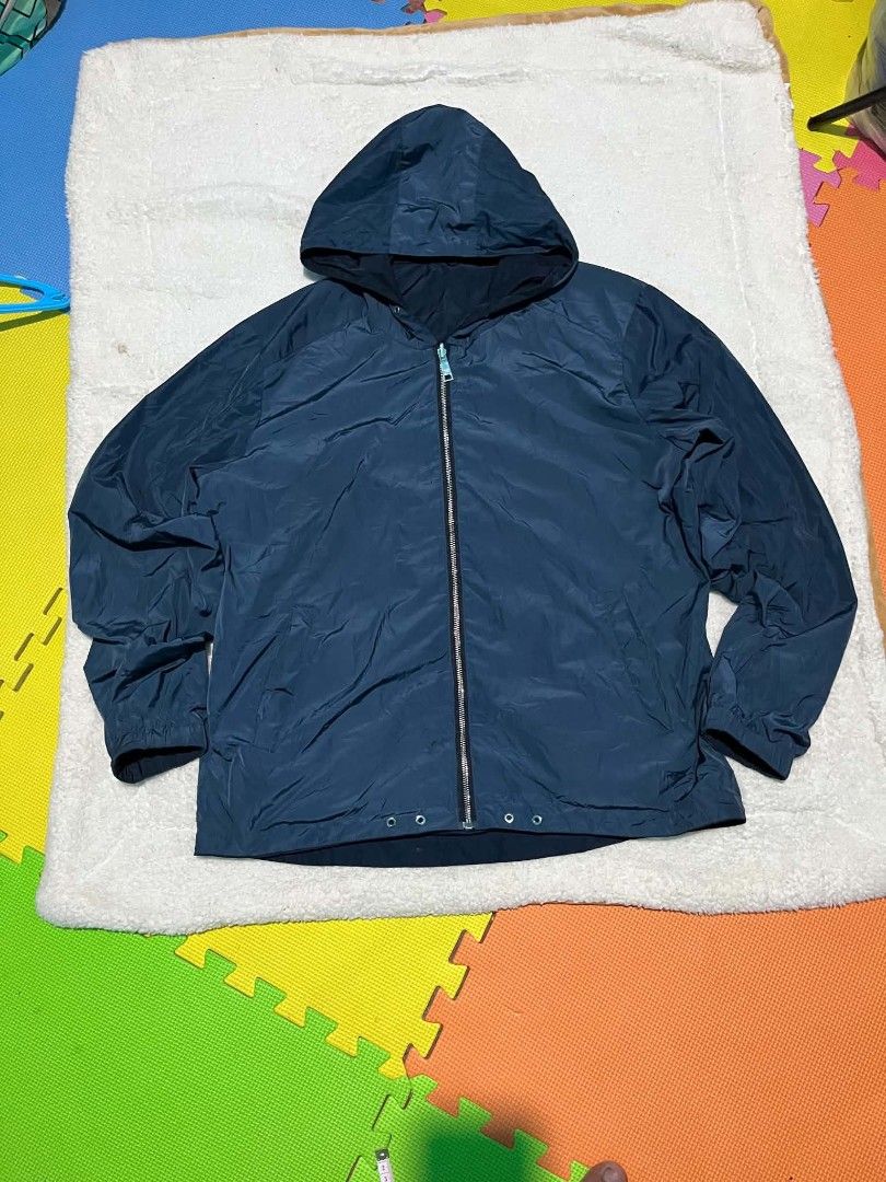 Prada Milano Reversible Hooded Jacket Navy Blue (Category: Coats, Jackets and Outerwear) located in Leyte. Submitted by carlthriftwearapparel (Listing ID 1463658938, Image 1). Description: - Navy blue hooded jacket - Reversible design - Zip-up front with Prada Milano zipper pull - Two zippered side pockets - Elasticated cuffs and hem - Lightweight material, ideal for layering - Perfect for casual wear.
