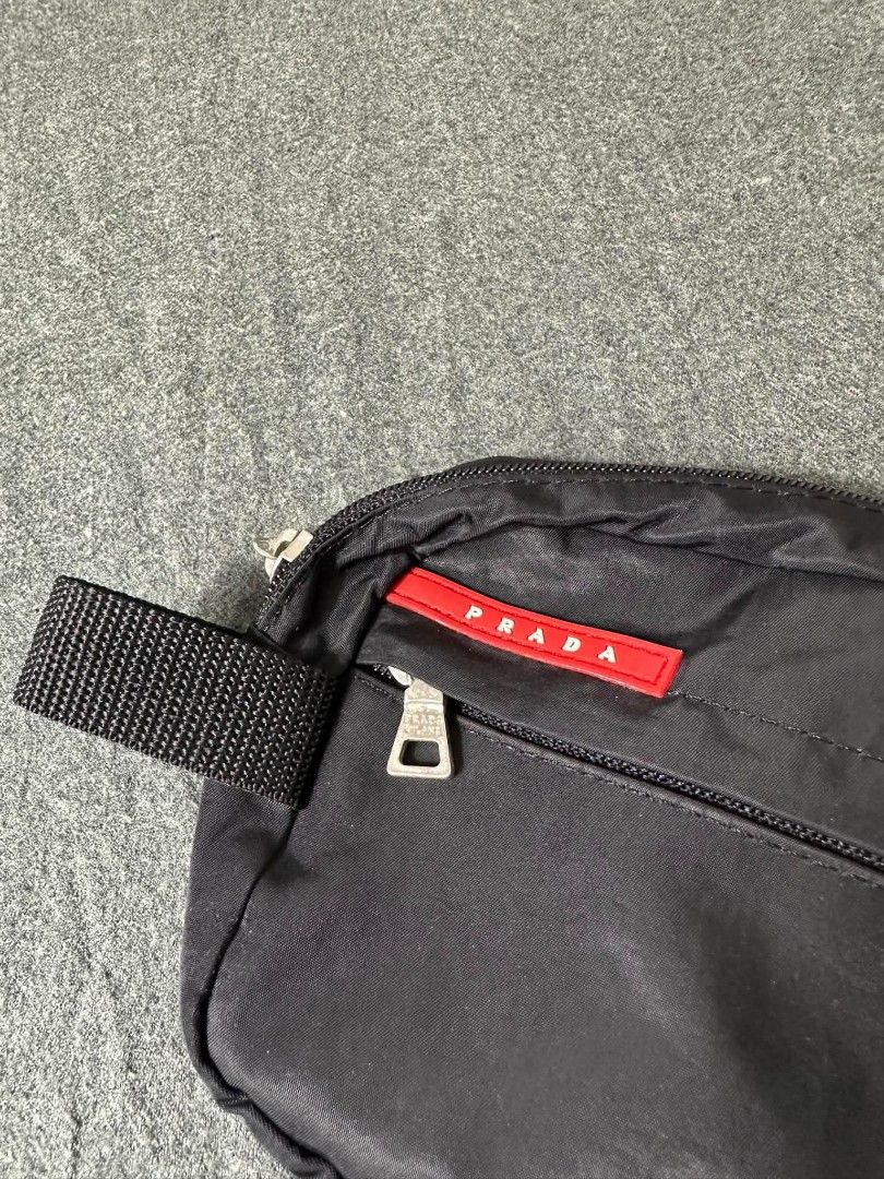 Prada Nylon Pouch Bag Black (Category: Luxury Bags & Wallets) located in Legazpi City. Submitted by rhumbalagu04057 (Listing ID 1463737571, Image 2). Description: - Authentic Prada pouch - Black nylon material - Front zip pocket - Main compartment - Interior with repeating Prada logo pattern - Branded 'Prada Milano' zipper pulls - Ideal for travel or everyday essentials.