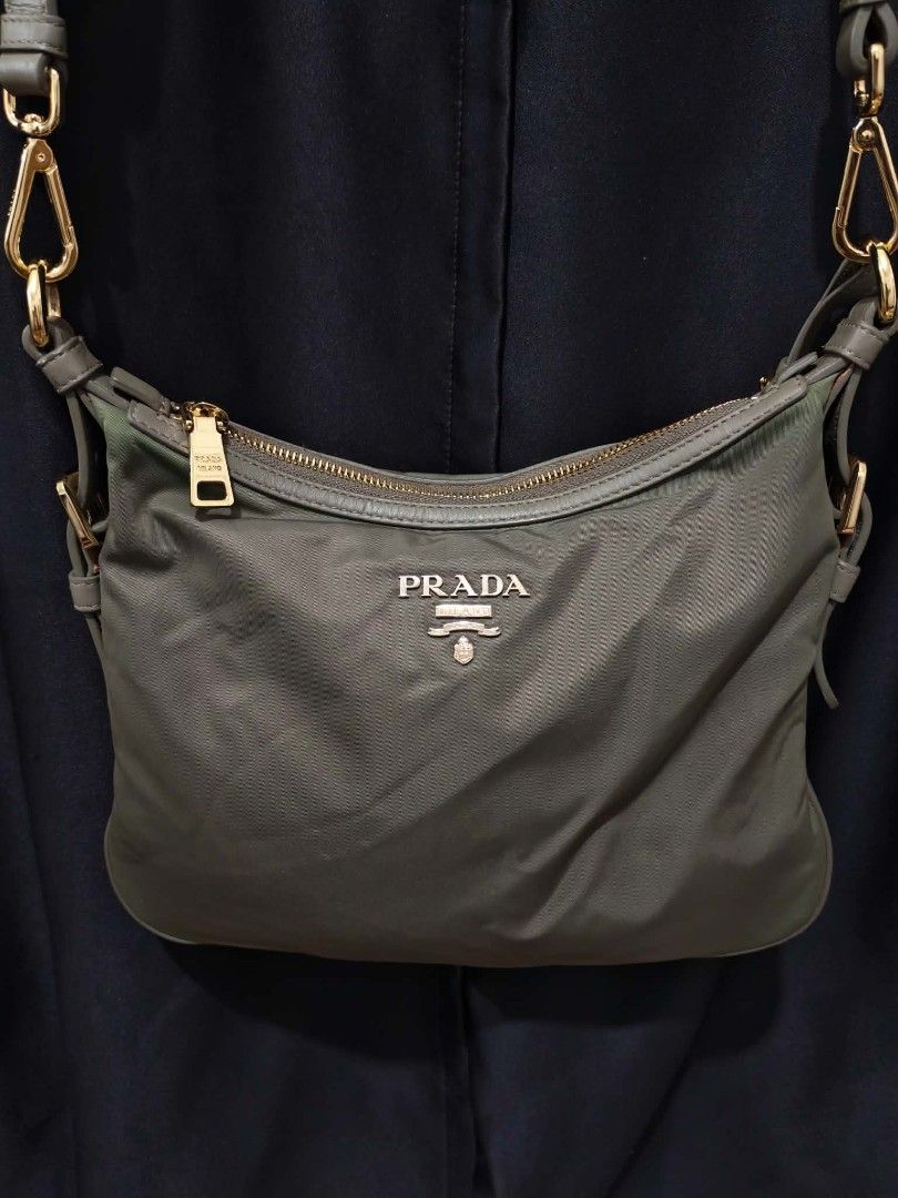 Prada Nylon Shoulder Bag Khaki Gold Hardware (Category: Luxury Bags & Wallets) located in Baguio. Submitted by solo_ukay (Listing ID 1463695821, Image 2). Description: - Authentic Prada shoulder bag - Durable nylon with leather trim - Gold-tone hardware - Secure zip closure - Branded interior lining - Interior tag reads '209' - Adjustable strap for comfort - Ideal for everyday use.