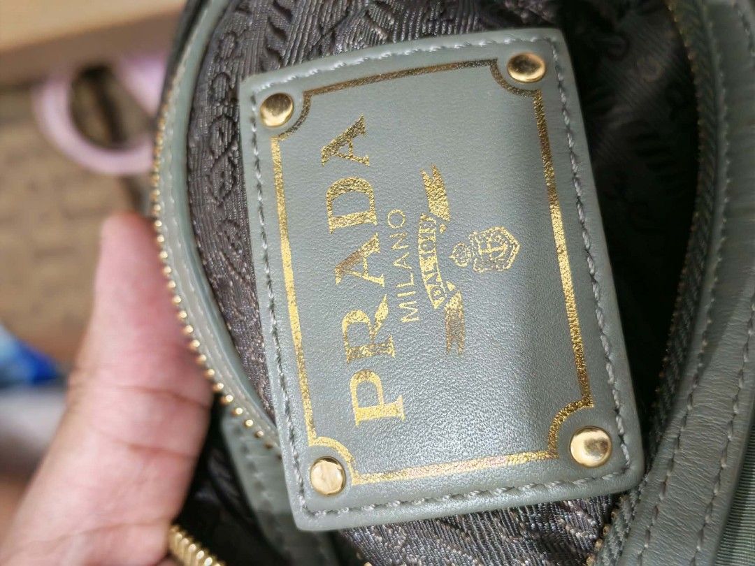 Prada Nylon Shoulder Bag Khaki Gold Hardware (Category: Luxury Bags & Wallets) located in Baguio. Submitted by solo_ukay (Listing ID 1463695821, Image 3). Description: - Authentic Prada shoulder bag - Durable nylon with leather trim - Gold-tone hardware - Secure zip closure - Branded interior lining - Interior tag reads '209' - Adjustable strap for comfort - Ideal for everyday use.