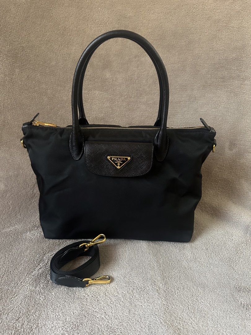 Prada Nylon Tessuto Tote Bag with Strap (Category: Luxury Bags & Wallets) located in Bacolod City. Submitted by katayellow (Listing ID 1463621829, Image 1). Description: - Authentic Black Prada Nylon Tote Bag - Saffiano Leather Trim & Handles - Gold-tone Hardware - Zipper Closure - Detachable Shoulder Strap Included - Four Protective Feet on Bottom - Ideal for Everyday Use ✅with Legitgrails .