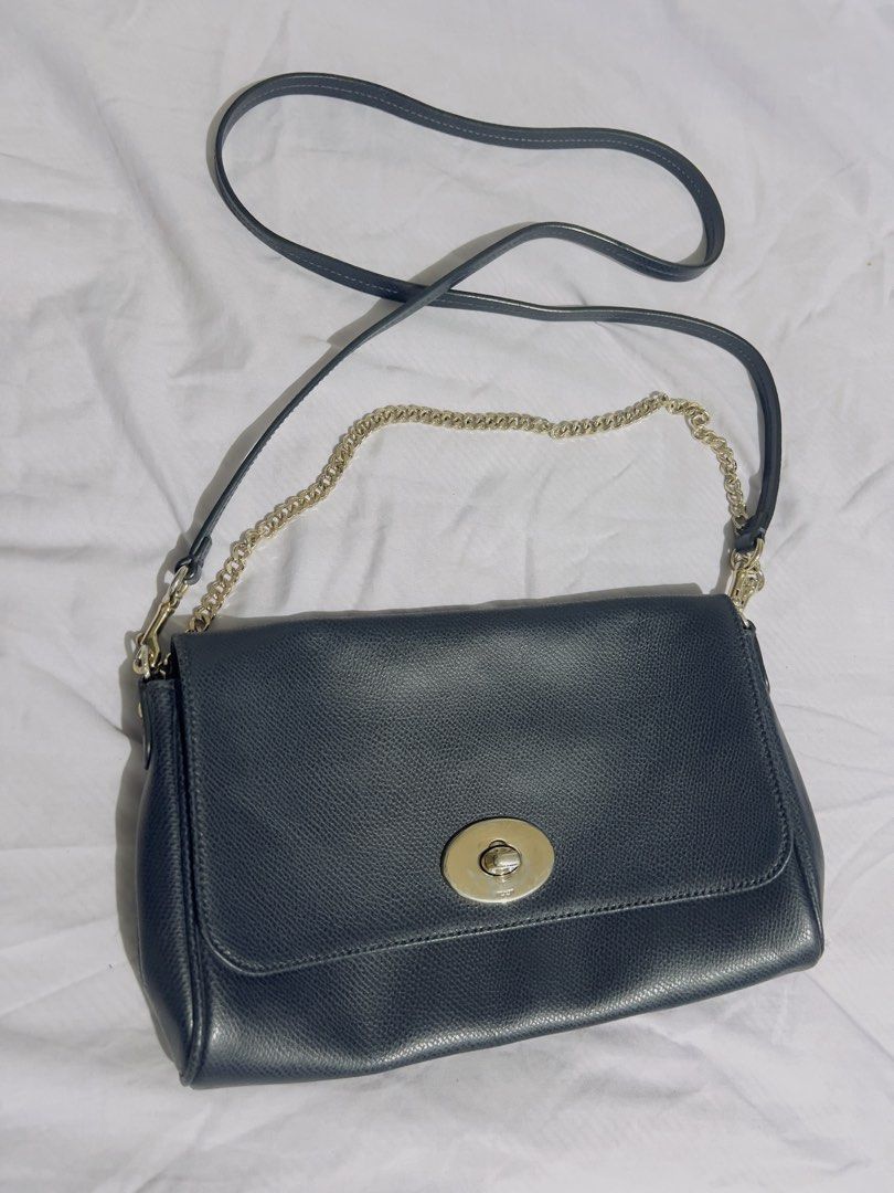 Preloved authentic Coach Pebbled Leather Crossbody Bag with Chain Strap (Category: Cross-body Bags) located in Binan City. Submitted by unicohijoxfudge (Listing ID 1463655631, Image 2). Description: - Dark blue pebbled leather crossbody bag - Secure gold turn-lock closure - Interior Coach creed patch - Detachable gold chain strap - Detachable leather shoulder strap - Versatile for everyday or evening wear Size: 9.5 x 6 inches height Delivery c/o 