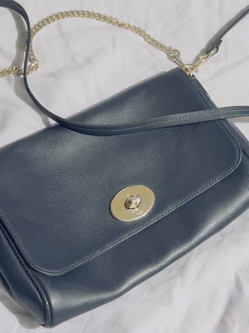 Preloved authentic Coach Pebbled Leather Crossbody Bag with Chain Strap (Category: Cross-body Bags) located in Binan City. Submitted by unicohijoxfudge (Listing ID 1463655631, Image 1). Description: - Dark blue pebbled leather crossbody bag - Secure gold turn-lock closure - Interior Coach creed patch - Detachable gold chain strap - Detachable leather shoulder strap - Versatile for everyday or evening wear Size: 9.5 x 6 inches height Delivery c/o 