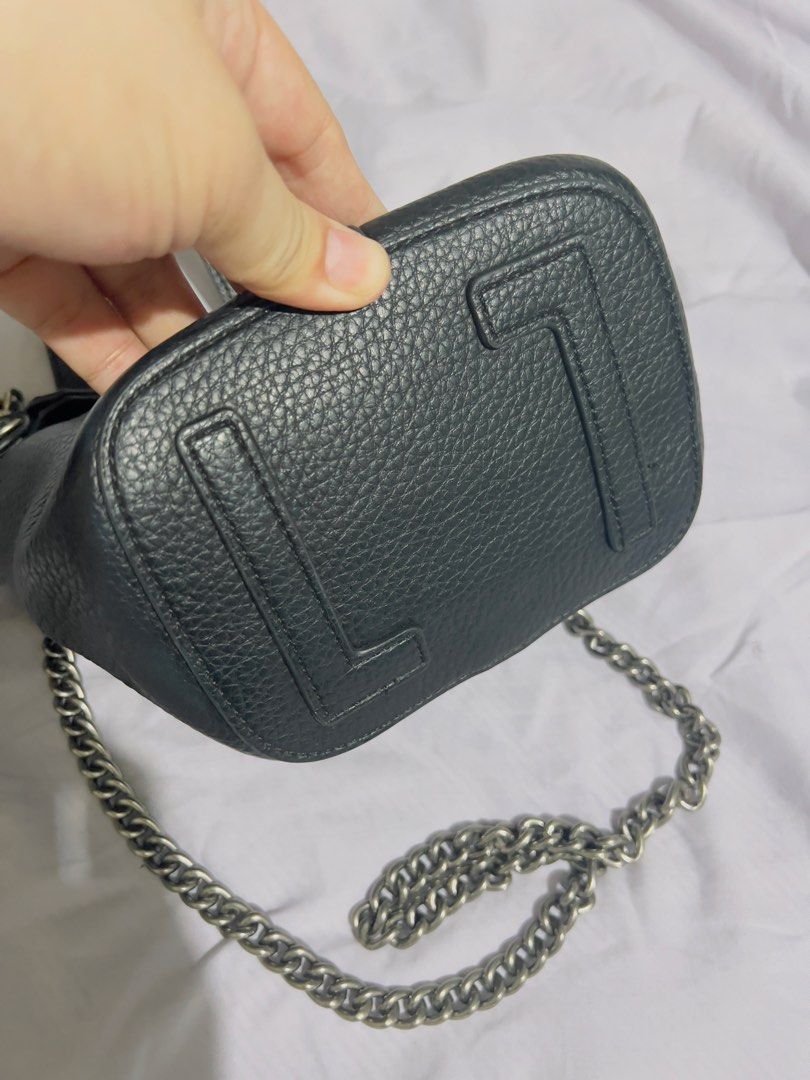 Preloved Black Leather Bucket Bag with Chain Strap (Category: Shoulder Bags) located in Binan City. Submitted by unicohijoxfudge (Listing ID 1463653098, Image 3). Description: - Black pebbled leather bucket bag - Top handles - Detachable chain strap - Interior zippered pouch - Silver hardware details - Stylish everyday bag - Plenty of space for essentials Size: 9 x 7 inches height Delivery fee c/o buyer Tags: Burberry Calvin Klein Coach Michael K