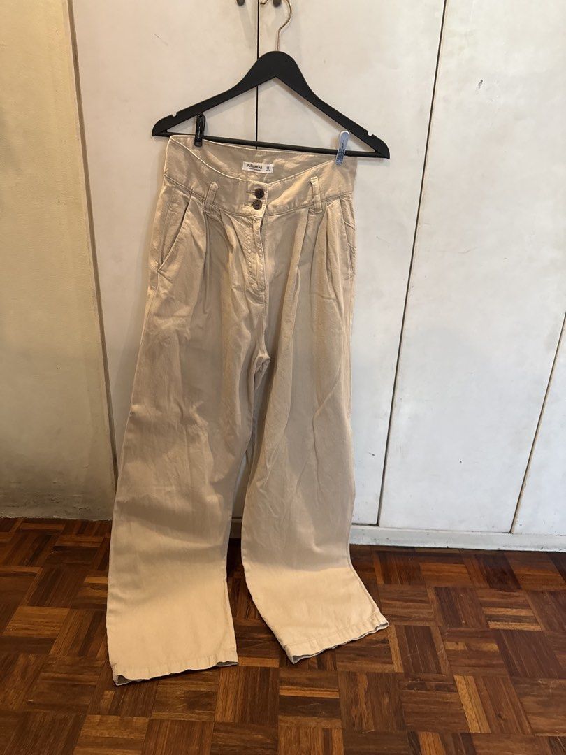 Pull & Bear Beige Wide Leg Pleated Pants Size S (Category: Jeans) located in Manila. Submitted by andromedanny (Listing ID 1463611684, Image 1). Description: - Brand: Pull & Bear - Color: Beige - Style: Wide leg pants - Closure: Double button - Details: Front pleats - Size: S - RFS: Decluttering.
