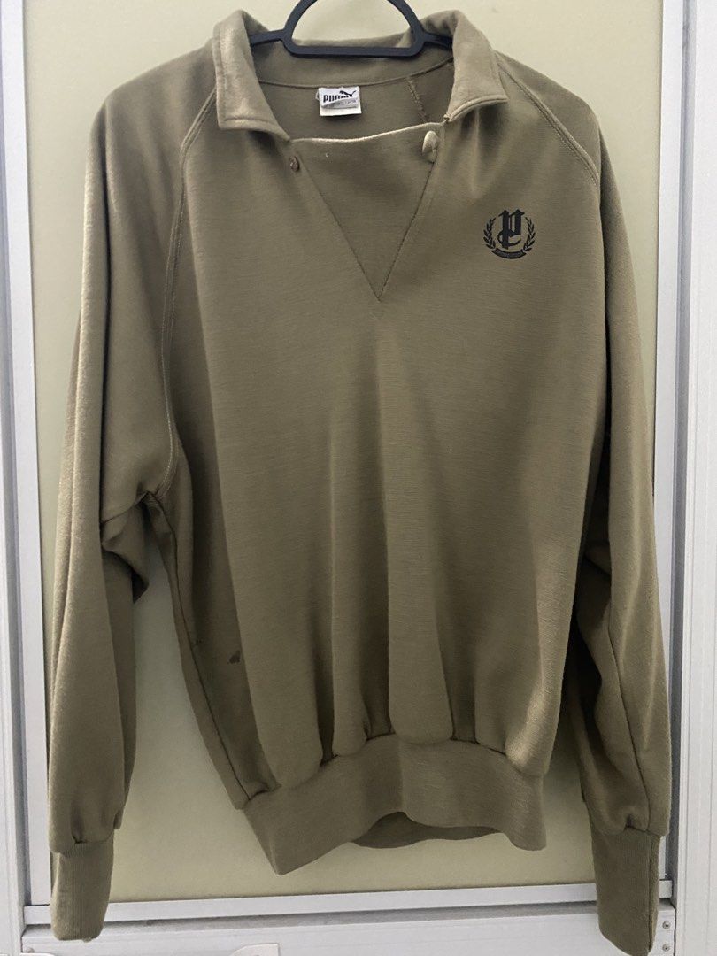 Puma Vintage Sweatshirt Khaki Green Collared Pullover (Category: Coats, Jackets and Outerwear) located in Malvar. Submitted by letharellano__71 (Listing ID 1463702795, Image 1). Description: - Vintage Puma sweatshirt - Khaki green color - Collared neckline with button closure - Elasticated cuffs and hem - Small embroidered Puma logo on right chest - Ideal for casual wear.