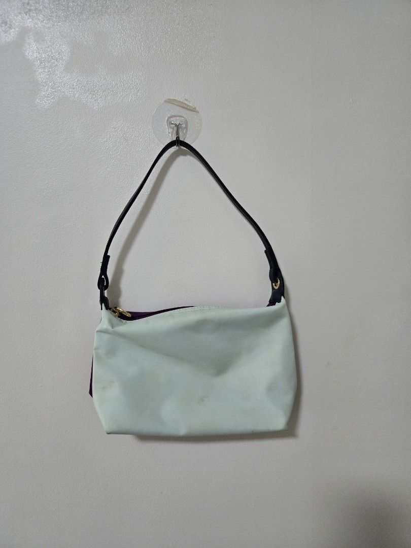 Purple and Mint Green Pouch Bag (Category: Purses & Pouches) located in Cagayan de Oro. Submitted by itsnaja (Listing ID 1463686765, Image 1). Description: - Cute pouch with purple exterior and mint green interior. - Zipper closure and black strap. - Small stain on the mint green interior (visible in the last photo). - Perfect for organizing small essentials. needs cleaning! perf kili kili bag & spacious rfs: dont use this as much!.
