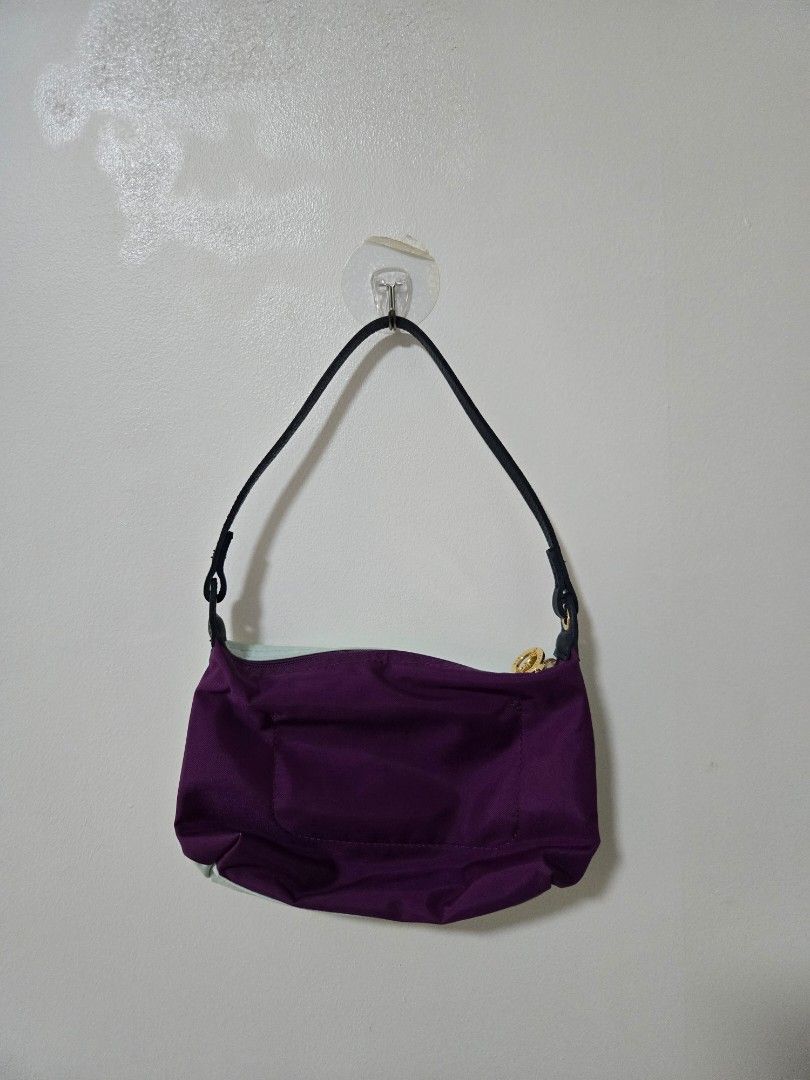 Purple and Mint Green Pouch Bag (Category: Purses & Pouches) located in Cagayan de Oro. Submitted by itsnaja (Listing ID 1463686765, Image 2). Description: - Cute pouch with purple exterior and mint green interior. - Zipper closure and black strap. - Small stain on the mint green interior (visible in the last photo). - Perfect for organizing small essentials. needs cleaning! perf kili kili bag & spacious rfs: dont use this as much!.