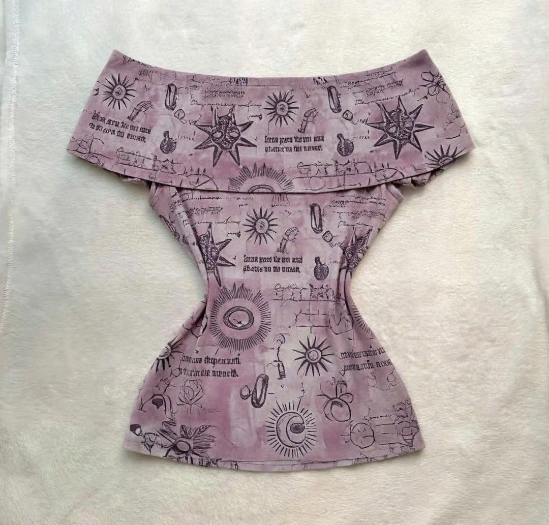 Purple Celestial Print Off-Shoulder Top (Category: Blouses) located in Manila. Submitted by angelic.clot (Listing ID 1463568175, Image 1). Description: - Cute off-shoulder design - Stretchy material for a comfortable fit - Unique celestial and script print featuring suns, moons, stars, and mystical symbols - Creates a witchy and mystical vibe - Fits snugly.
