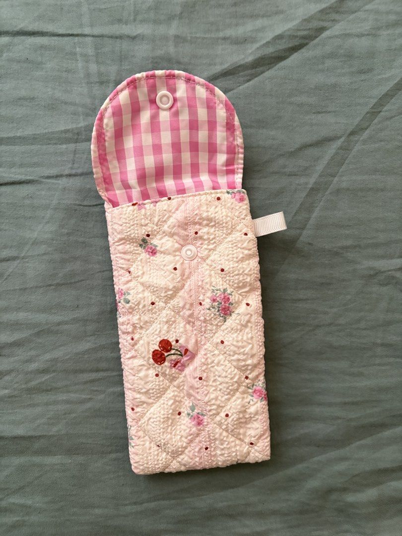 Quilted Pink Floral Pouch (Category: Purses & Pouches) located in Manila. Submitted by anabri (Listing ID 1463609556, Image 2). Description: - Adorable quilted pouch with a charming pink floral pattern. - Secure snap button closure to keep your items safe. - Lined with a sweet pink and white gingham fabric. - Features a delicate white ribbon loop on the side. - Ideal for organizing small essentials like glasses, pens, makeup, and more..