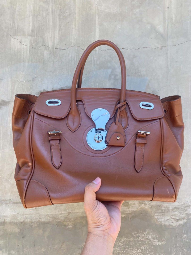 Ralph Lauren Ricky Bag 33 (Category: Luxury Bags & Wallets) located in Caloocan City. Submitted by thon0806 (Listing ID 1463652462, Image 1). Description: - Authentic Ralph Lauren brown leather satchel bag - Made in Italy - Secure turn-lock closure - Comfortable top handles - Minor scuffs on bottom corners - Small mark on one handle - Clean interior - Ideal for everyday use.