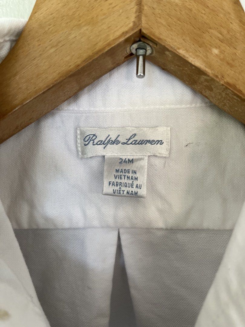 Ralph Lauren White Button-Down Shirt Boys 24M (Category: Babies & Kids Fashion) located in Tabuelan. Submitted by franzloyd181453 (Listing ID 1463618252, Image 3). Description: - Classic white button-down shirt - Brand: Ralph Lauren - Features signature polo player logo embroidery on chest - Made in Vietnam - Ideal for smart casual or formal occasions - Easily pairs with trousers or shorts.