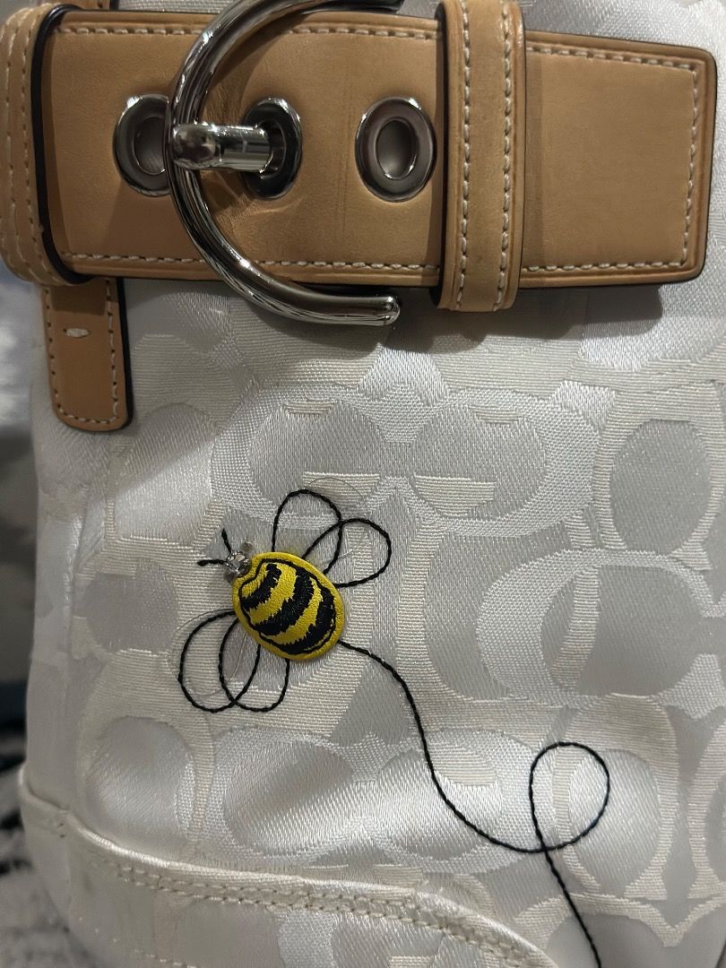 Rare Bumble Bee Tote Bag (Category: Luxury Bags & Wallets) located in Cebu City. Submitted by isellhere123.543 (Listing ID 1463736266, Image 2). Description: - White Coach monogram canvas handbag - Cute embroidered bee detail - Genuine leather strap with buckle closure - Interior Coach authenticity tag - Model number: N9M053-5077 - Ideal size for everyday essentials.