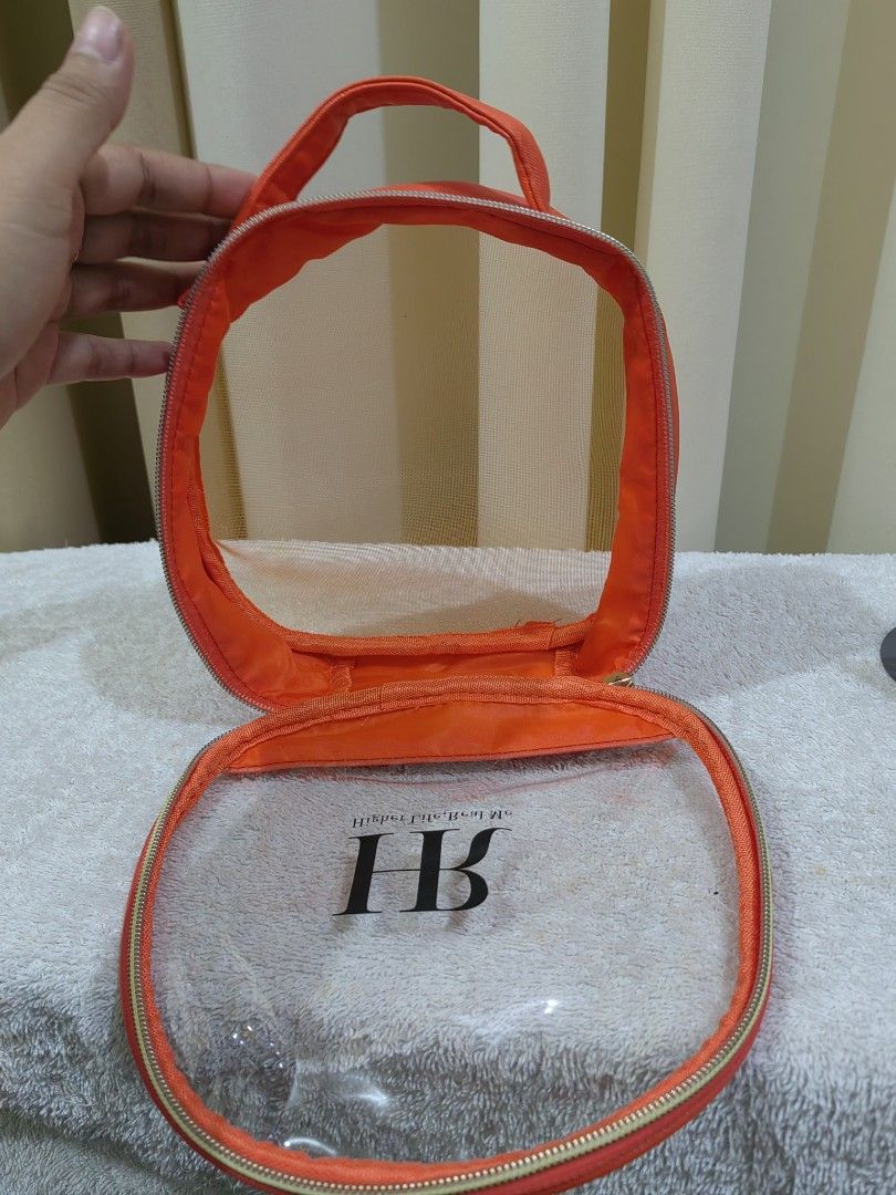 Real Me Orange Mesh Cosmetic Bag (Category: Purses & Pouches) located in Makati City. Submitted by prelovedtreatedwithlove (Listing ID 1463739371, Image 3). Description: - Vibrant orange cosmetic bag - Clear mesh front for easy visibility - Secure zipper closure - Convenient top handle for carrying - Ideal for organizing makeup, toiletries, or travel essentials - Easy to clean material - Compact size, perfect for on-the-go - like new .