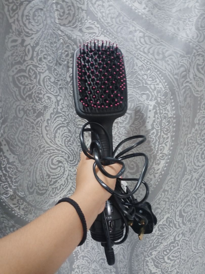 Revlon One-Step Hair Dryer and Volumizer (Category: Hair) located in Caloocan City. Submitted by silenthawk.739a57 (Listing ID 1463626317, Image 3). Description: - Revlon Hair Dryer Brush - Color: Black and Pink - Dries and styles hair in one step - Tangle-free bristles for smooth results - Cord wraps around the base for easy storage - Ideal for quick and efficient styling.