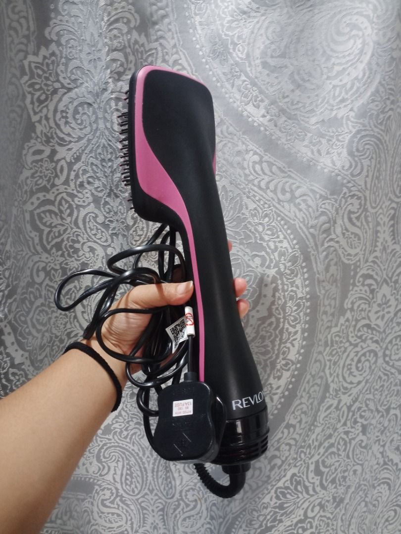 Revlon One-Step Hair Dryer and Volumizer (Category: Hair) located in Caloocan City. Submitted by silenthawk.739a57 (Listing ID 1463626317, Image 1). Description: - Revlon Hair Dryer Brush - Color: Black and Pink - Dries and styles hair in one step - Tangle-free bristles for smooth results - Cord wraps around the base for easy storage - Ideal for quick and efficient styling.