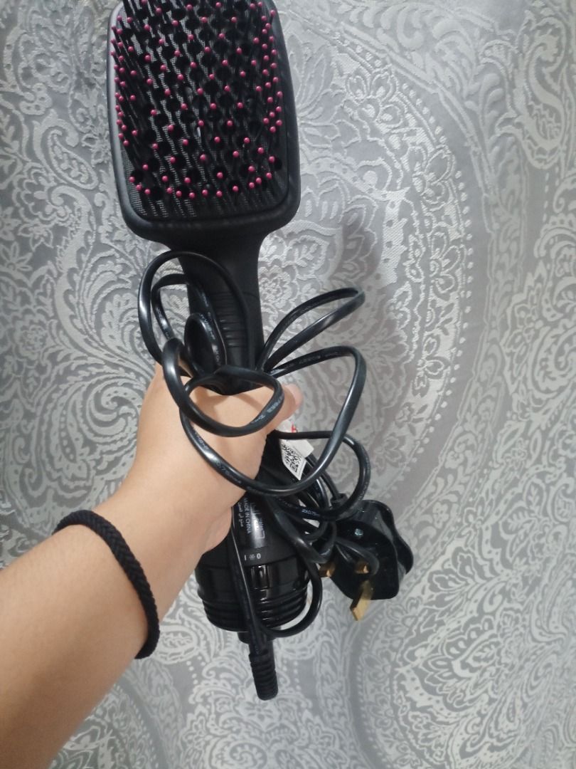 Revlon One-Step Hair Dryer and Volumizer (Category: Hair) located in Caloocan City. Submitted by silenthawk.739a57 (Listing ID 1463626317, Image 2). Description: - Revlon Hair Dryer Brush - Color: Black and Pink - Dries and styles hair in one step - Tangle-free bristles for smooth results - Cord wraps around the base for easy storage - Ideal for quick and efficient styling.