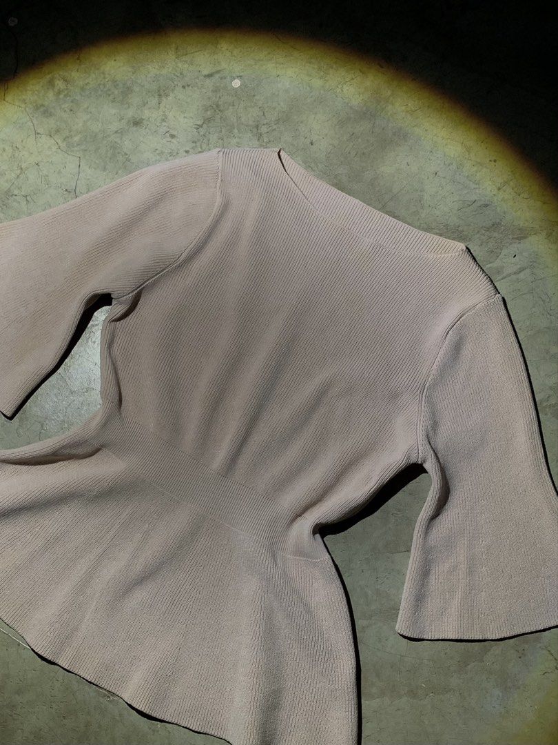 Ribbed Peplum Top with Bell Sleeves (Category: Sleeveless) located in Rizal. Submitted by pcesspscl145 (Listing ID 1463664478, Image 2). Description: - Lightweight ribbed knit fabric - Flattering peplum silhouette - Elegant flared bell sleeves - Classic round neckline - Cinched waist for a feminine shape - Perfect for dressing up or down.