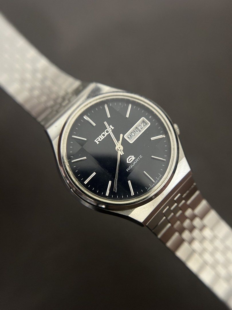 Ricoh Riquartz Blue Dial Day-Date Watch – Ref. 580003 (Category: Men's Watches) located in Quezon City. Submitted by bobby.brown. (Listing ID 1463667283, Image 1). Description: Ricoh Riquartz Blue Dial Day-Date Watch – Ref. 580003 Estimated BMBY: August 1980 An exceptional vintage Japanese quartz dress watch by Ricoh, featuring a sleek, integrated stainless steel case paired with its original multi-link Jubilee-style bracelet. The sharp blue dial