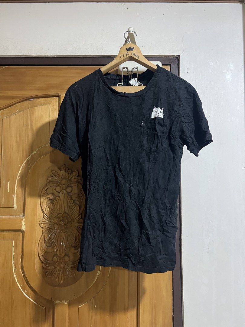 RIPNDIP Black T-Shirt with Cat Graphic (Category: Shirts) located in Valencia. Submitted by thrifttomaniac_1225 (Listing ID 1463633342, Image 1). Description: - Brand: RIPNDIP - Design: Iconic Lord Nermal cat graphic on front pocket and large graphic on back - Style: Short sleeves, crew neck t-shirt - Condition: Great for casual wear.