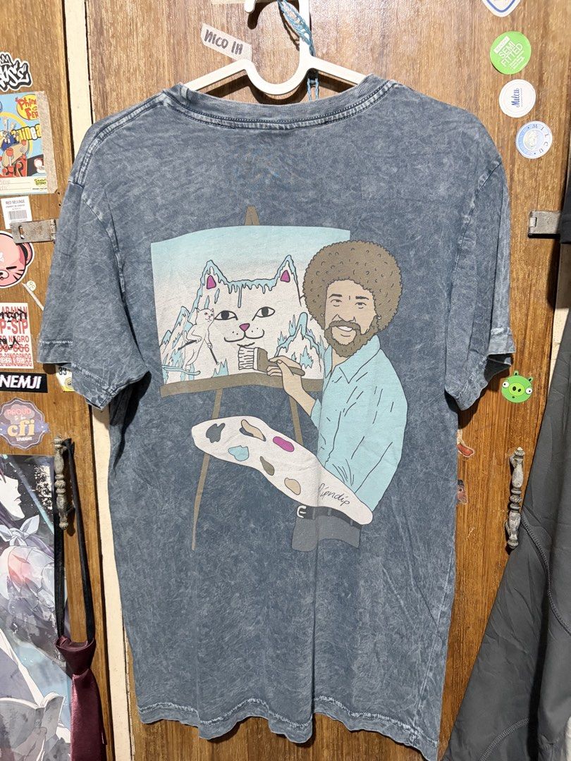 Ripndip T-Shirt Bob Ross Cat Graphic Tee (Category: Tshirts & Polo Shirts ) located in Imus. Submitted by frootiloots4103 (Listing ID 1463572964, Image 3). Description: - Grey Ripndip T-shirt - Size: Small - 21x29 - Back Graphic: Cat painting with Bob Ross - Front Graphic: Small paintbrush - Style: Washed-out look - Ideal for: Ripndip enthusiasts OPEN FOR NEGO (best if aspack) 📍Imus, Cavite 4103 Can do meetups within Imus Area 🚚 J&T or Lalamove