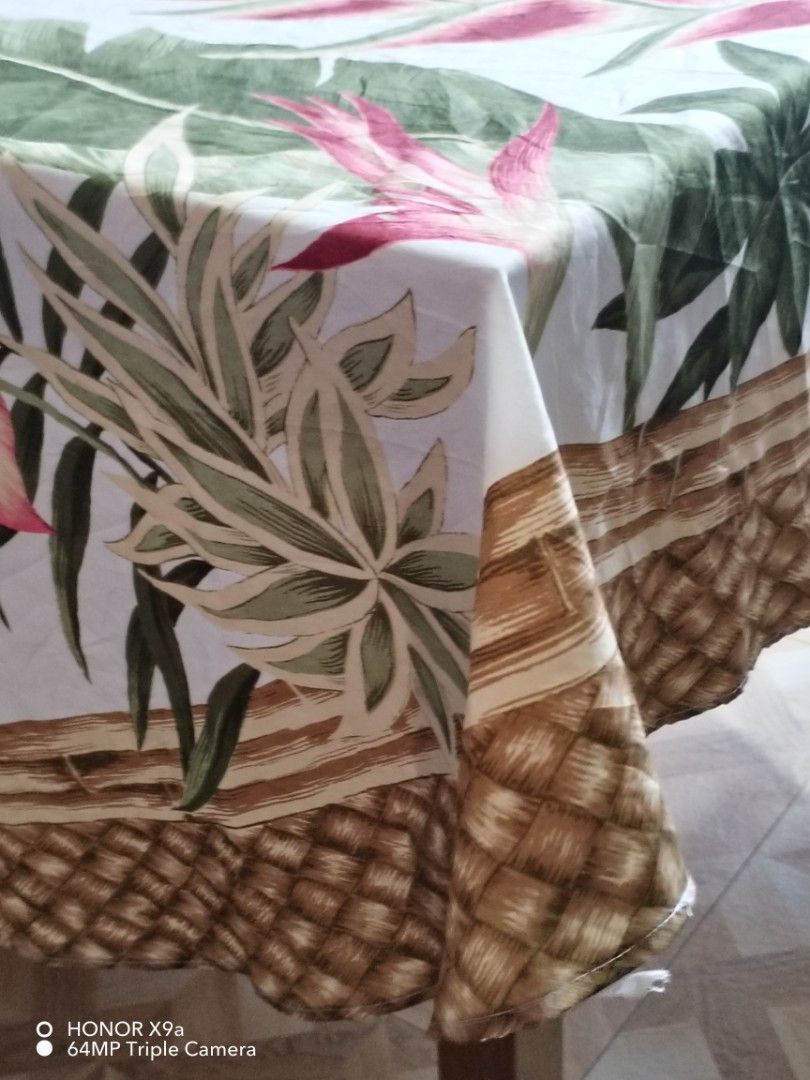 Round Table Topper w/ washable stain (Category: Table Linen & Textiles) located in Muntinlupa City. Submitted by arciagamaryann68 (Listing ID 1463603888, Image 3). Description: - Round table topper with a beautiful tropical design. - Features vibrant pink heliconia flowers and lush green leaves. - Washable and stain-resistant material for easy cleaning. - Adds a touch of paradise to your home decor. - Minor, washable stains are present but not ve