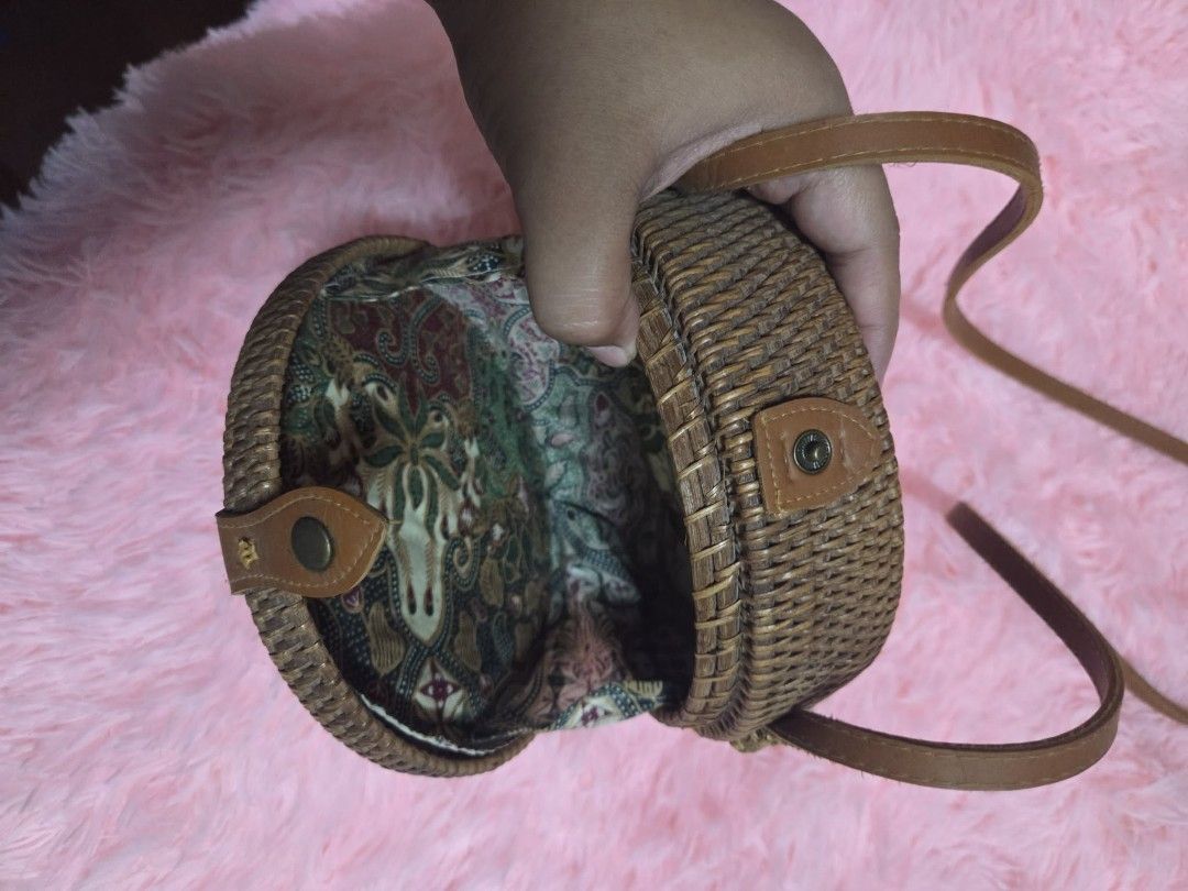 Round Woven Rattan Bag with Leather Strap and Batik Lining (Category: Beach Bags) located in Manila. Submitted by 3dec76162b7a19e007e3ecb867113a (Listing ID 1463615422, Image 2). Description: - Cute round rattan bag - Natural woven material - Features a leather strap and closure - Lined with vibrant, colorful batik fabric - Ideal for beach trips or casual outings - Unique and eye-catching design.