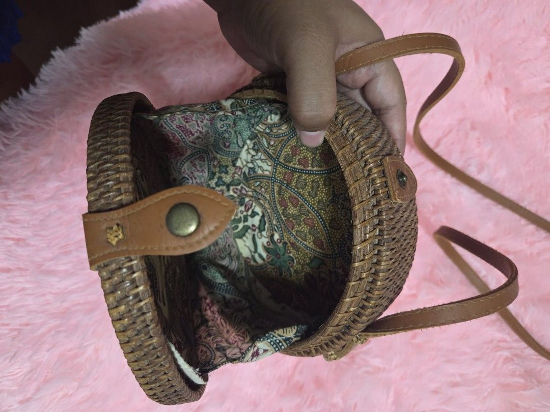 Round Woven Rattan Bag with Leather Strap and Batik Lining (Category: Beach Bags) located in Manila. Submitted by 3dec76162b7a19e007e3ecb867113a (Listing ID 1463615422, Image 3). Description: - Cute round rattan bag - Natural woven material - Features a leather strap and closure - Lined with vibrant, colorful batik fabric - Ideal for beach trips or casual outings - Unique and eye-catching design.